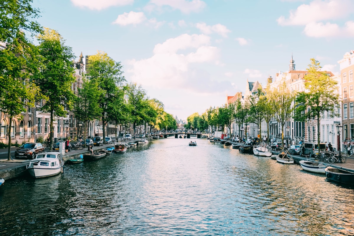 Amsterdam skyline at sunset — departure city for flights to Paris